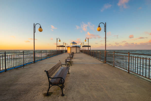 istock jetty on the baltic sea at sunset in winter. 1094383652