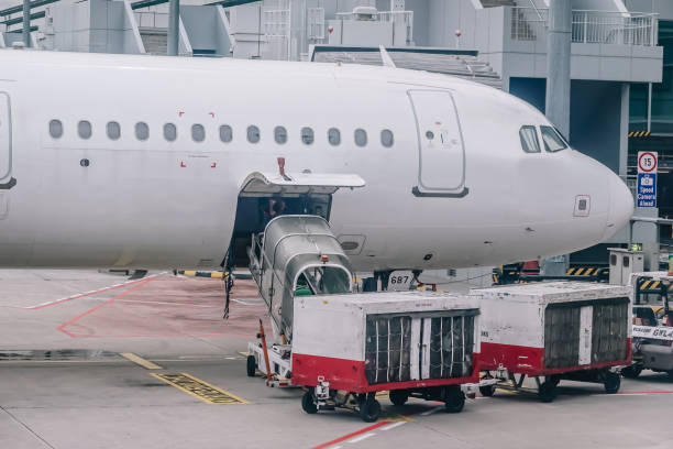 istock Loading cargo on the plane in airport, view through window. 1094383680