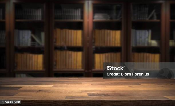 Blurred Bookshelf In Small Home Library With Table Top Product Display Stock Photo - Download Image Now