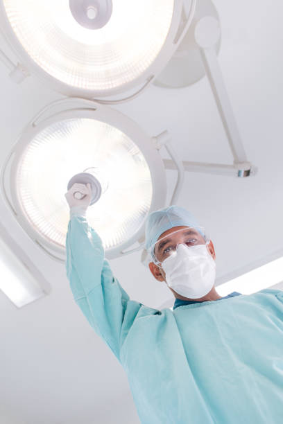 istock Low angle view of doctor holding lamp and looking down 1094387280