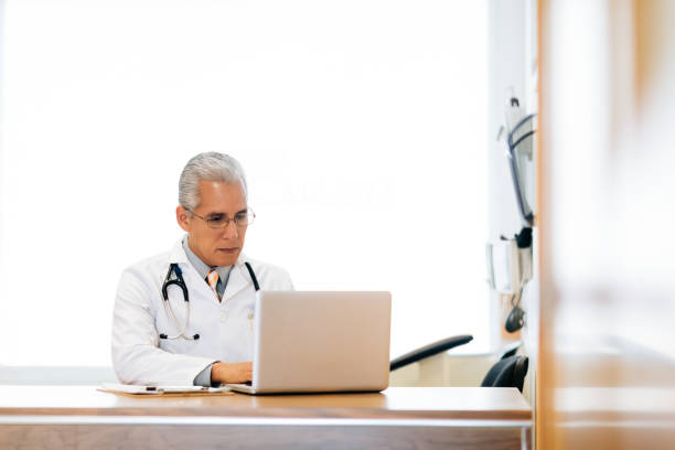 istock Male doctor sitting at desk and working 1094387340