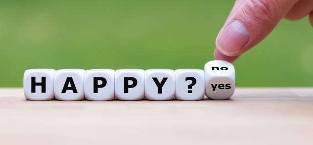 istock Being happy? Hand turns a dice and changes the word 