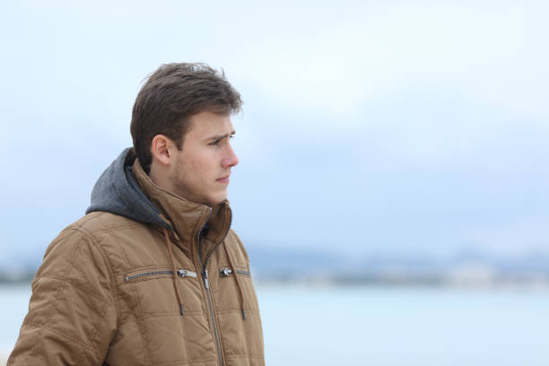 istock Sad man looking away on the beach 1094390330