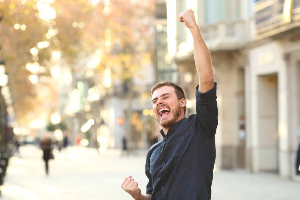 istock Excited man raising arms celebrating success 1094391430