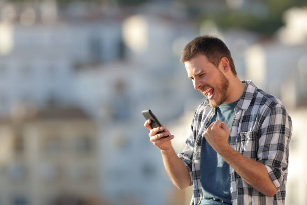 istock Excited man checking phone content at sunset 1094391608