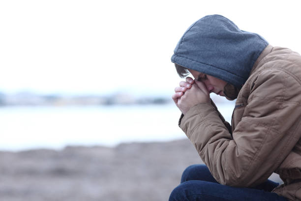 istock Sad boy complaining in winter on the beach 1094391616
