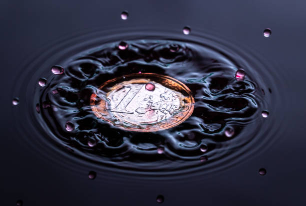 istock red colored water drop splashing on a one euro coin 1094392118