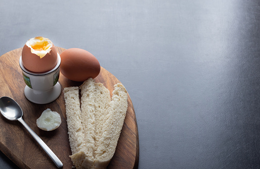 breakfast boiled eggs with white bread on a table