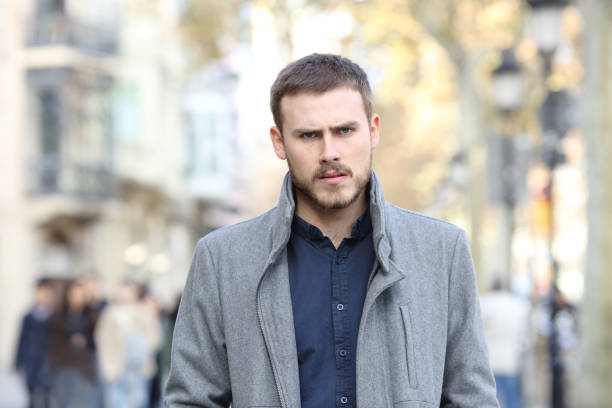 istock Angry man walking in the street looking at camera 1094392564