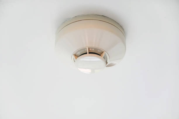 istock Smoke fire detector mounted on roof in condo 1094393408