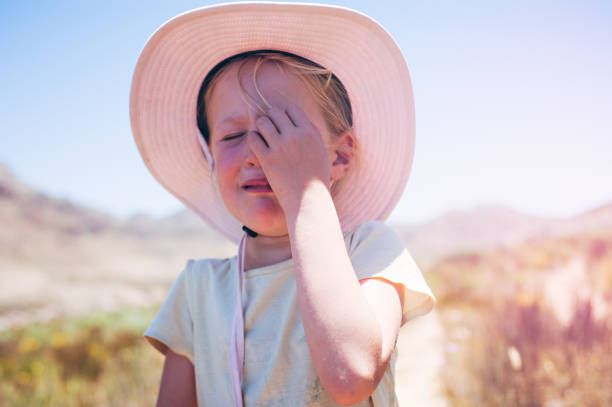 little girl with a big hat giving a kiss to camera on the beach. Instant print photo