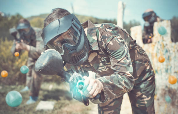 istock Female paintball player shooting with gun 1094396446