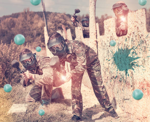 istock Paintball team running with marker guns 1094396456