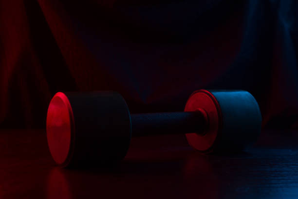 istock metal barbell on dark background 1094396800