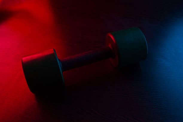 istock metal barbell on dark background 1094396838