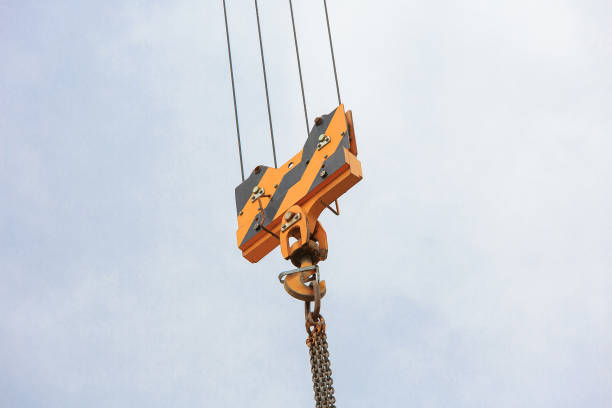 istock Crane load hook against the sky with trails and chain. 1094397020