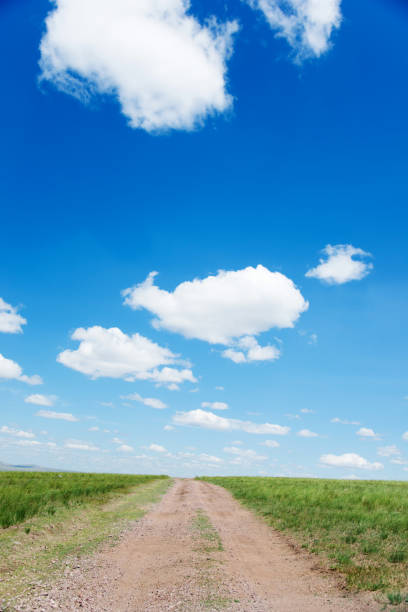 istock Dirt road and blue sky 1094397102