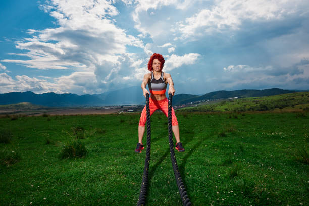 istock sportive woman with battle rope 1094399804