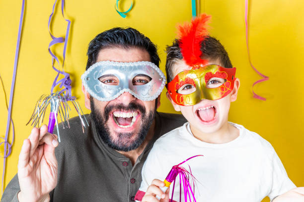 istock Father and son celebrating Carnival with masks 1094399990