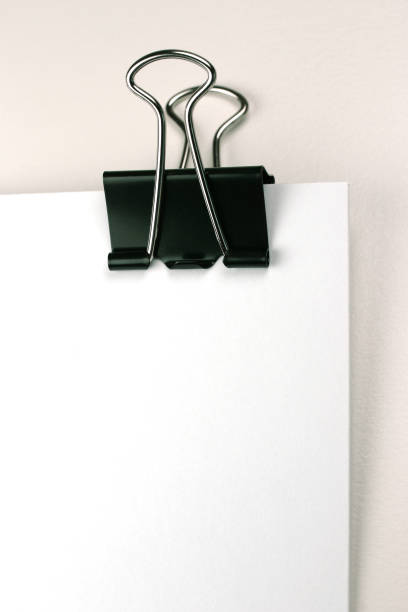 istock Metal Paper Clip on Blank White Paper 1094404690