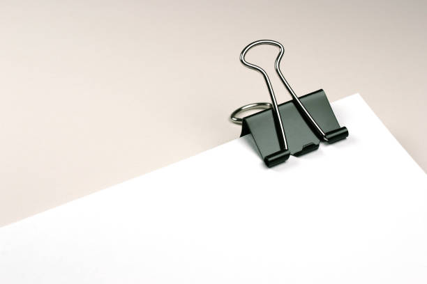istock Metal Paper Clip on Blank White Paper 1094404696