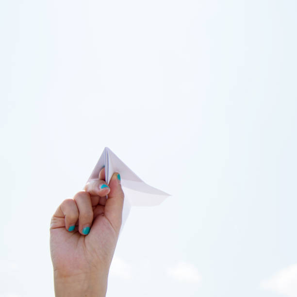 istock Hand holding a paper plane ready to fly 1094407108