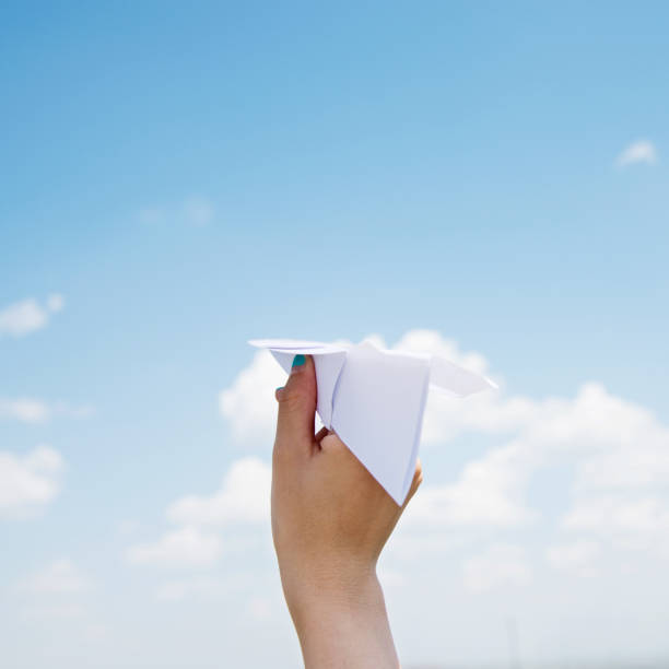 istock Hand holding a paper plane ready to fly 1094407220