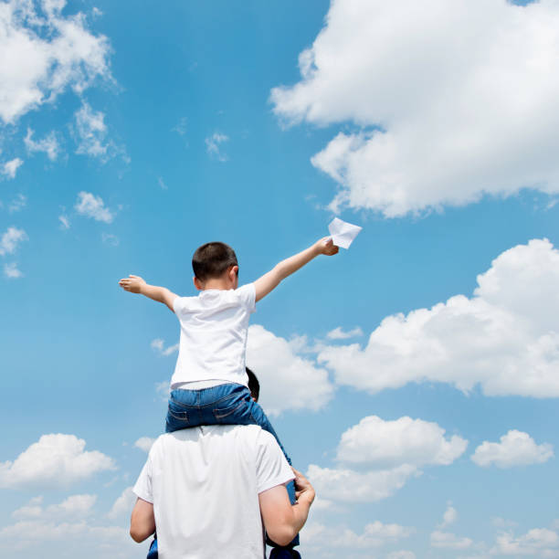 istock Son and father play paper airplane 1094409676