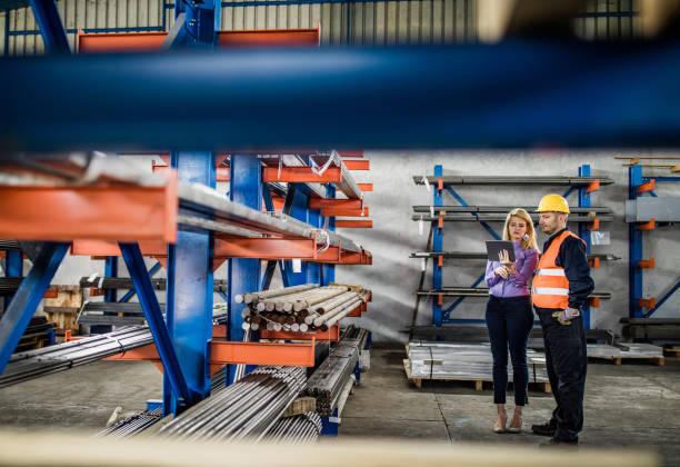 istock Manual worker and female manager working on touchpad in steel mill. 1094411072