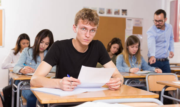 istock Schoolboy is learning and answering the question on paper 1094413290