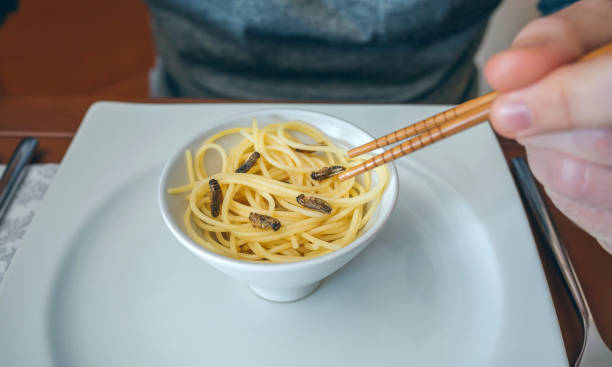 istock Man eating spaghetti and crickets 1094413592