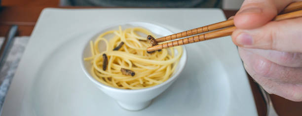 istock Man eating spaghetti and crickets 1094413594