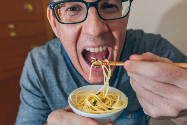 istock Man eating spaghetti and crickets 1094413604