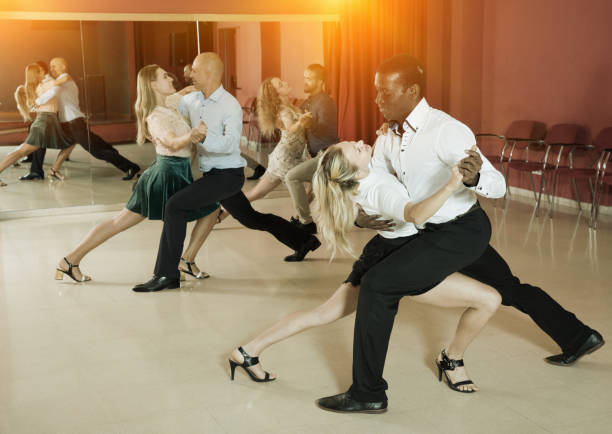 istock Adult pairs dancing tango movements in modern dance studio 1094414682