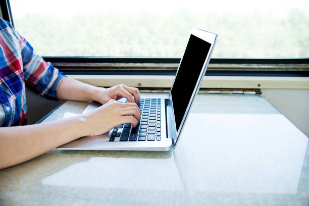 istock Asian woman on train using laptop 1094415010