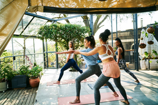 istock Instructor teaching warrior position to females 1094420464