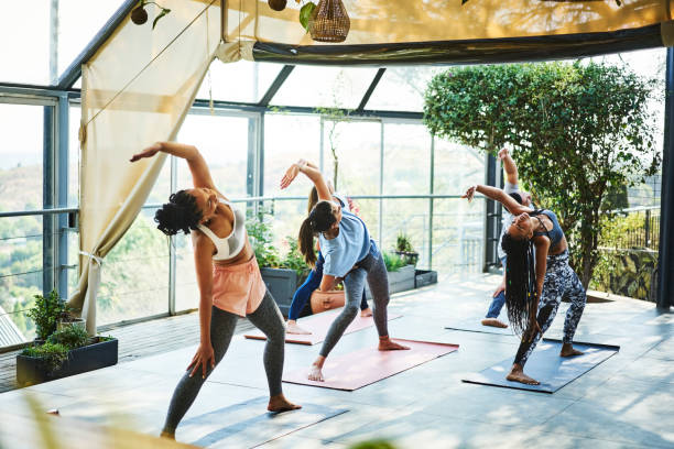 istock Instructor teaching yoga position on mat at porch 1094420888