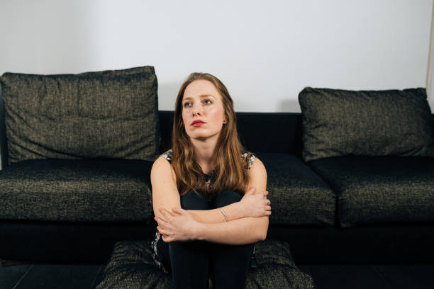 istock Alone and anxious young woman at home 1094423712