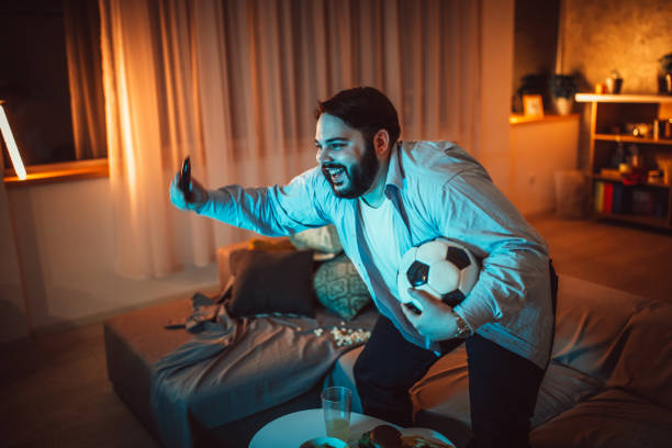 istock Fat man watching soccer game 1094423756