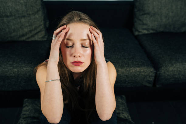 istock Alone and anxious young woman at home 1094423836