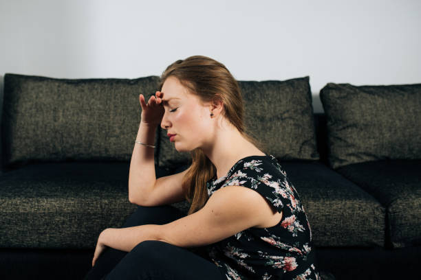 istock Alone and anxious young woman at home 1094423868