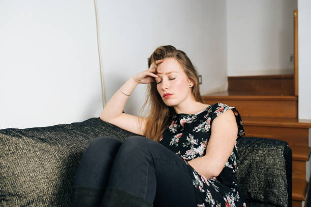 istock Alone and anxious young woman at home 1094423990
