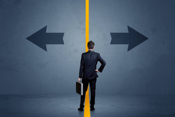 istock Business person choosing between two options separated by a yellow border arrow 1094424606