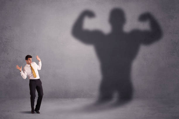 istock Business man looking at his own strong fit shadow concept 1094425826