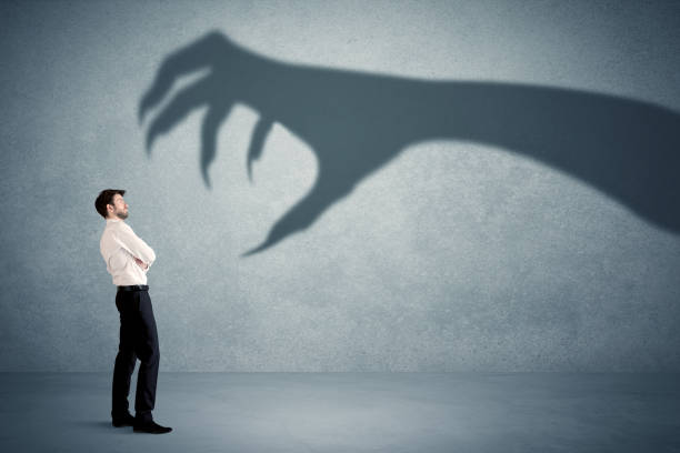 business person afraid of a big monster claw shadow concept - devil demon hell evil imagens e fotografias de stock