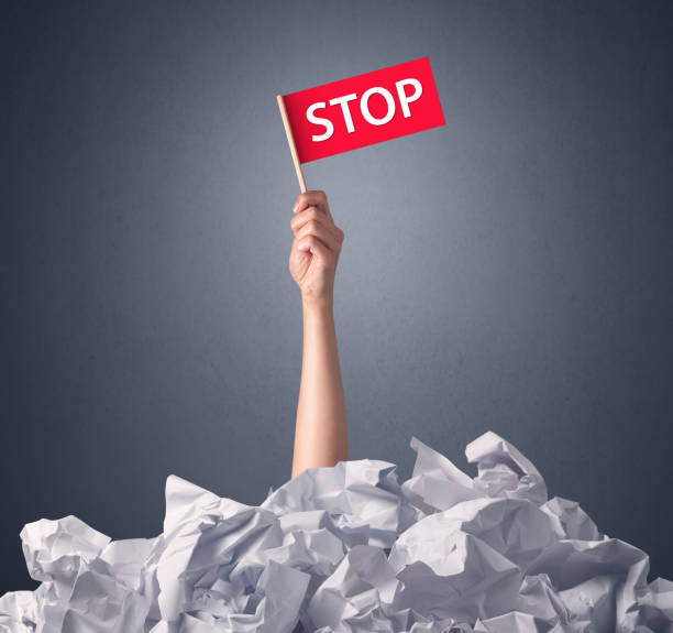 istock Female hand holding stop sign 1094427018
