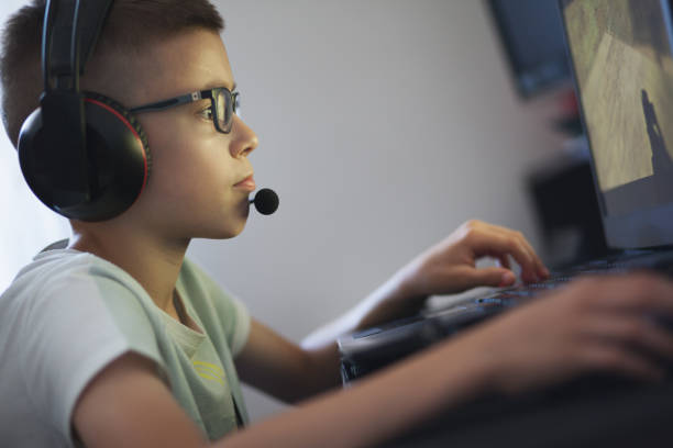 istock Cute boy playing game-GAMER 1094427914