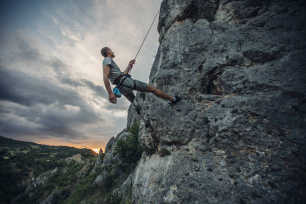 istock Disability man climbing high on rock mountain 1094429778