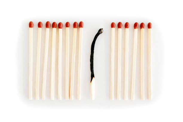 istock Row of matches, one is burnt 1094435262