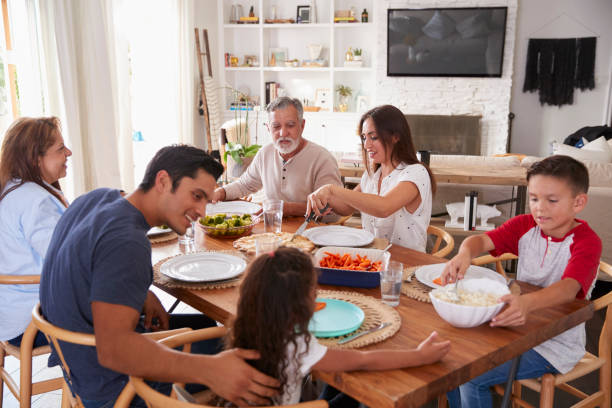 istock Three generation Hispanic family sitting at the table before dinner 1094437268
